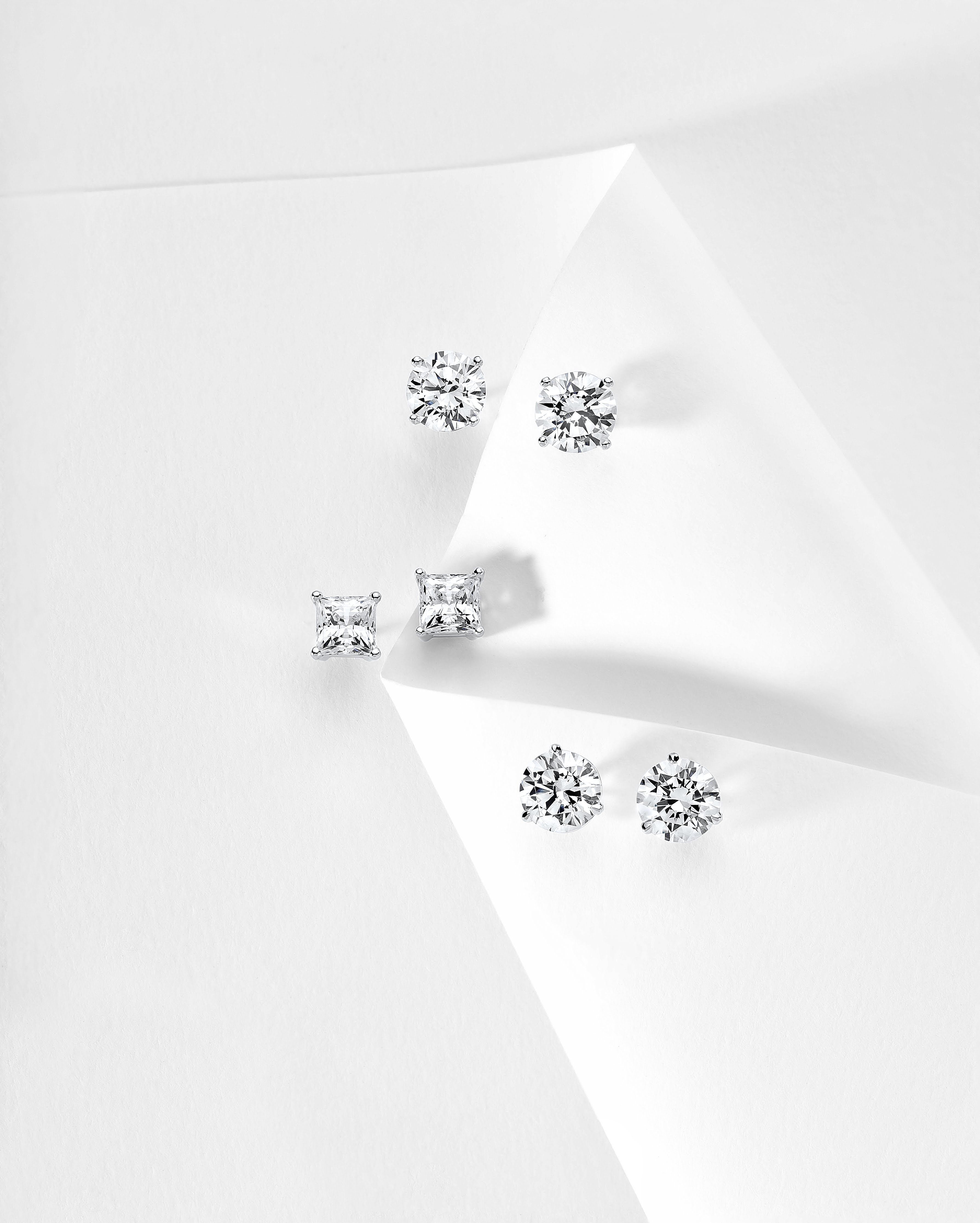 Photo of three pairs of diamond stud earrings