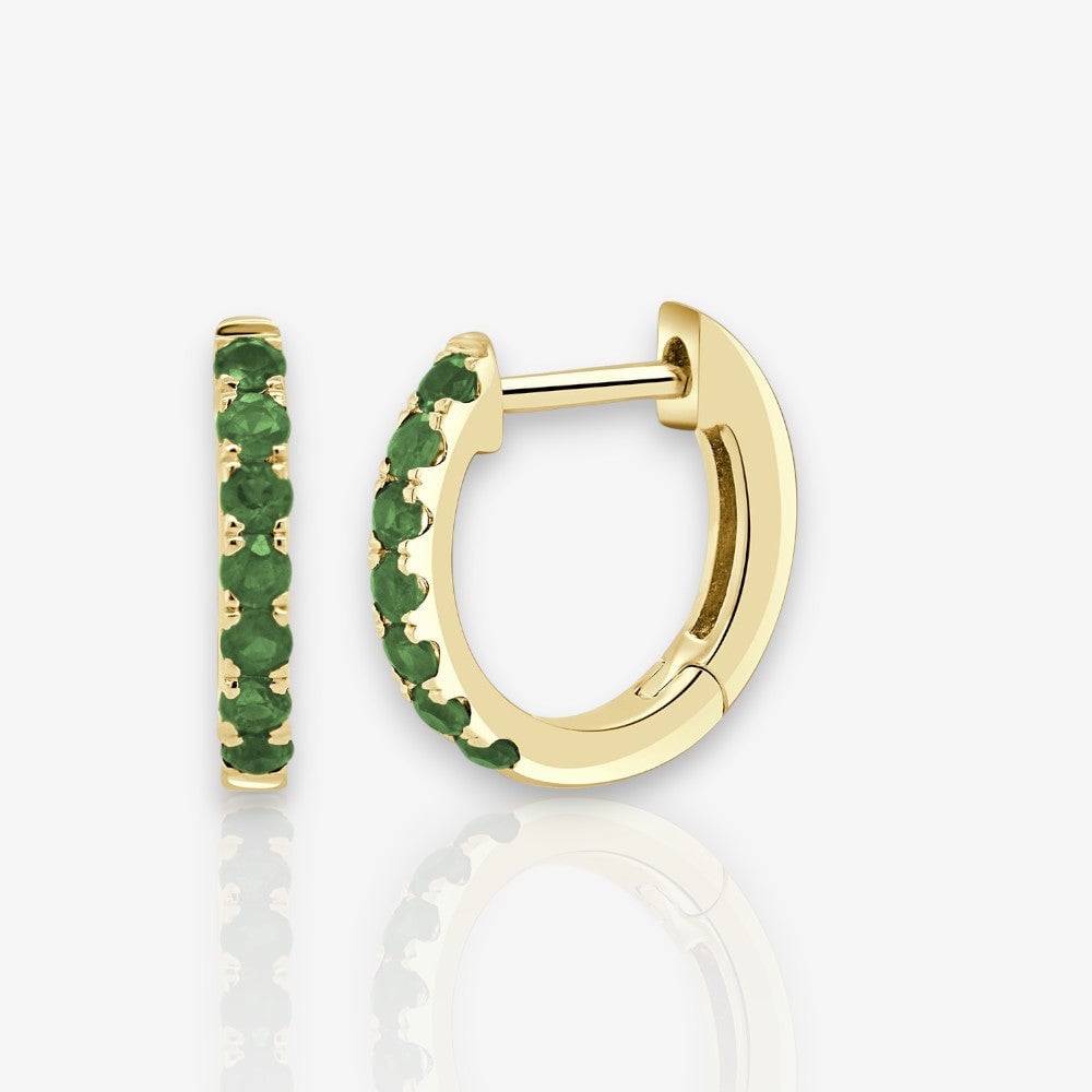 Image of emerald huggie earrings set in yellow gold