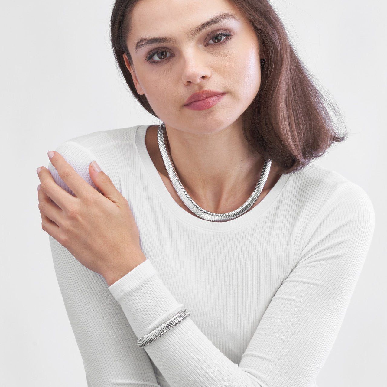 Image of model wearing a silver bracelet and necklace