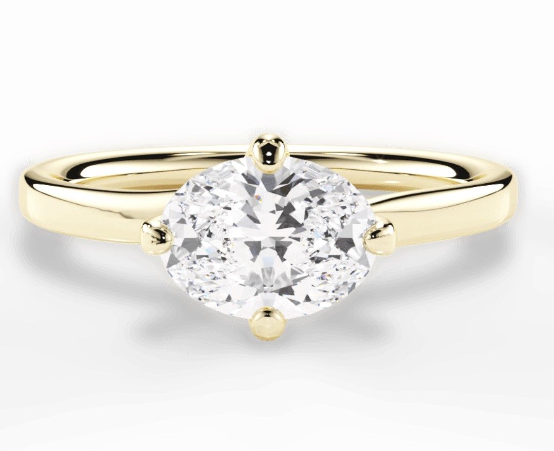 Image of east-west set diamond engagement ring on yellow gold band