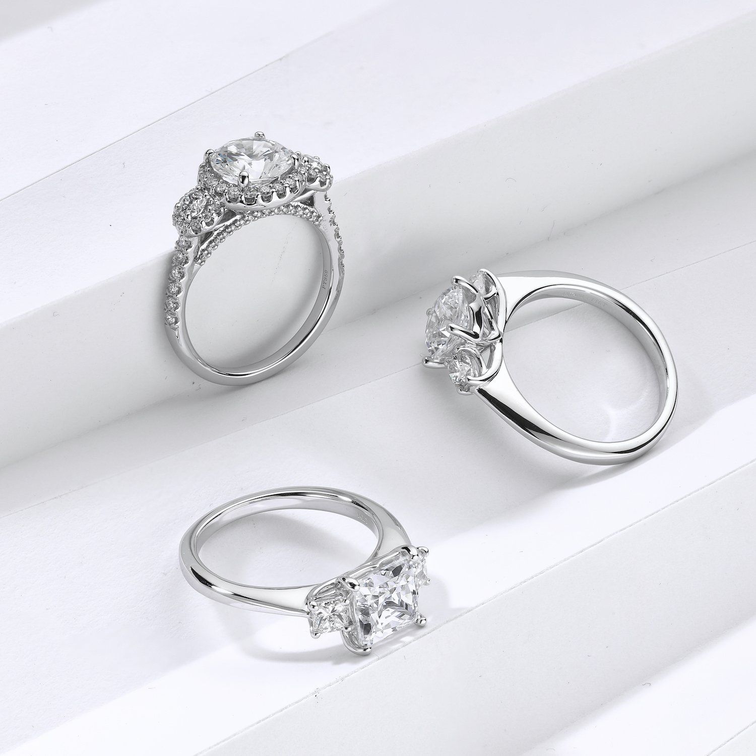 three platinum engagement rings 