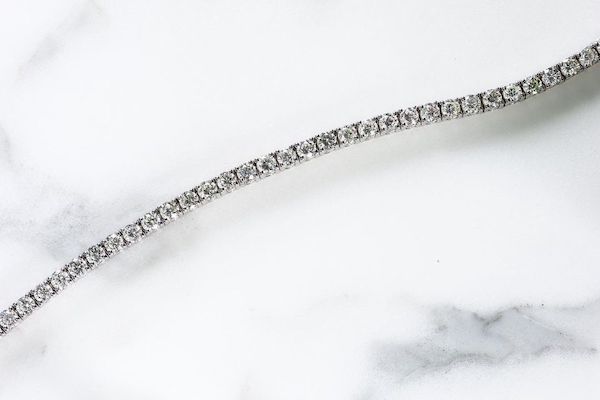 diamond tennis bracelet on marble surface