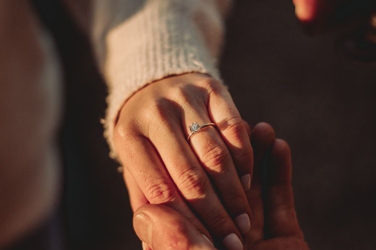 diamond engagement ring on woman's finger