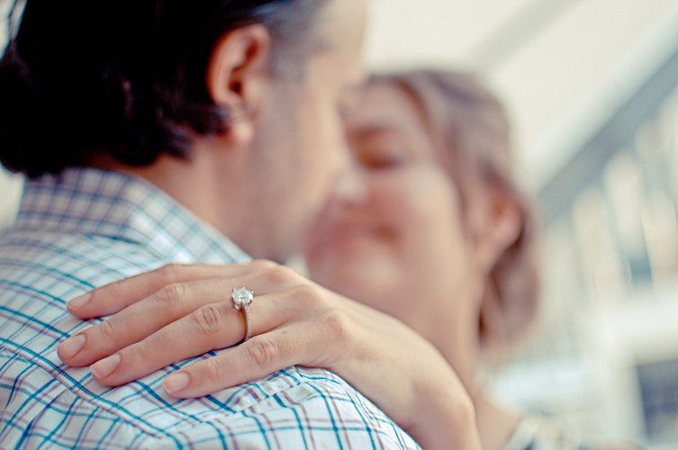 woman with hand on her fiancé