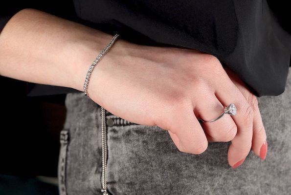 woman wearing diamond tennis bracelet and diamond ring